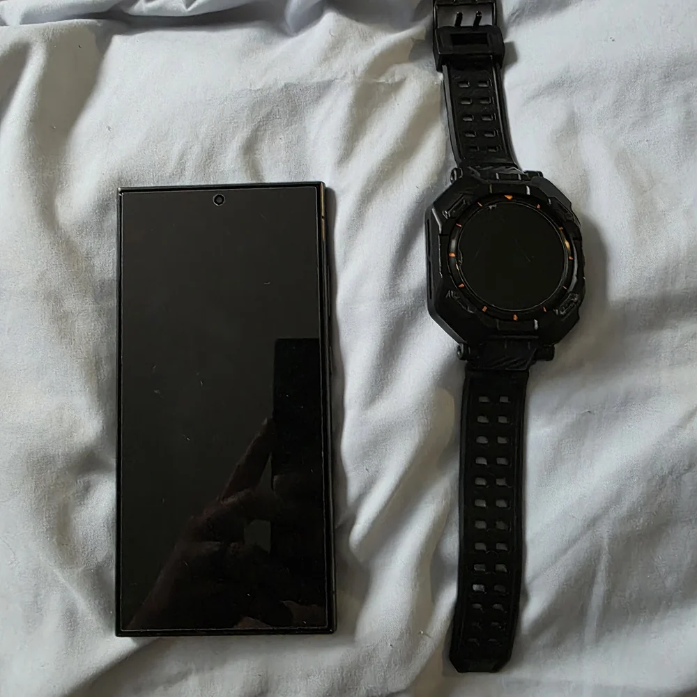Samsung Black Smartphone with Black Watch and Orange Accents